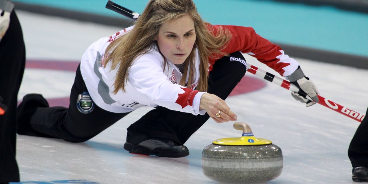 Female athlete playing winter sport of curling on the ice